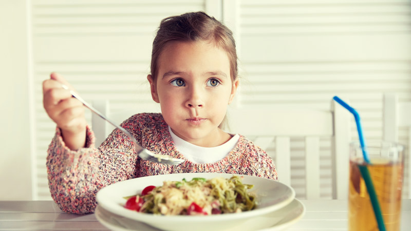 little-girl-eating-pasta-for-dinner-at-restaurant-PJPYWNM Vegetarian diet for children and teens