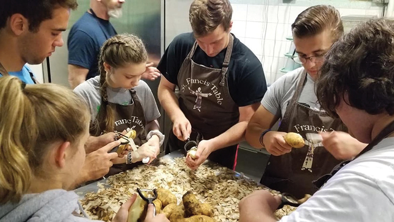 Members-of-the-St.-Mark's-youth-group-peel-potatoes-for-St.-Francis-Kitchen-in-Toronto.-From-left-to-right,-Peyton-Fulk,-Kevin-Kuhn,-Skye-Matteson,-Even-Winans,-Avery-Charles-and-Henry-Charles